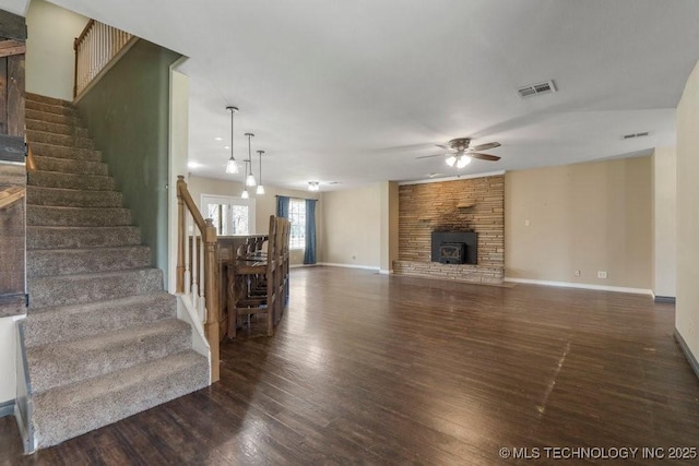 9012 S 49th W Ave, Tulsa, OK 74131 - unfurnished living room featuring ceiling fan, dark wood finished floors, stairs, and a fireplace