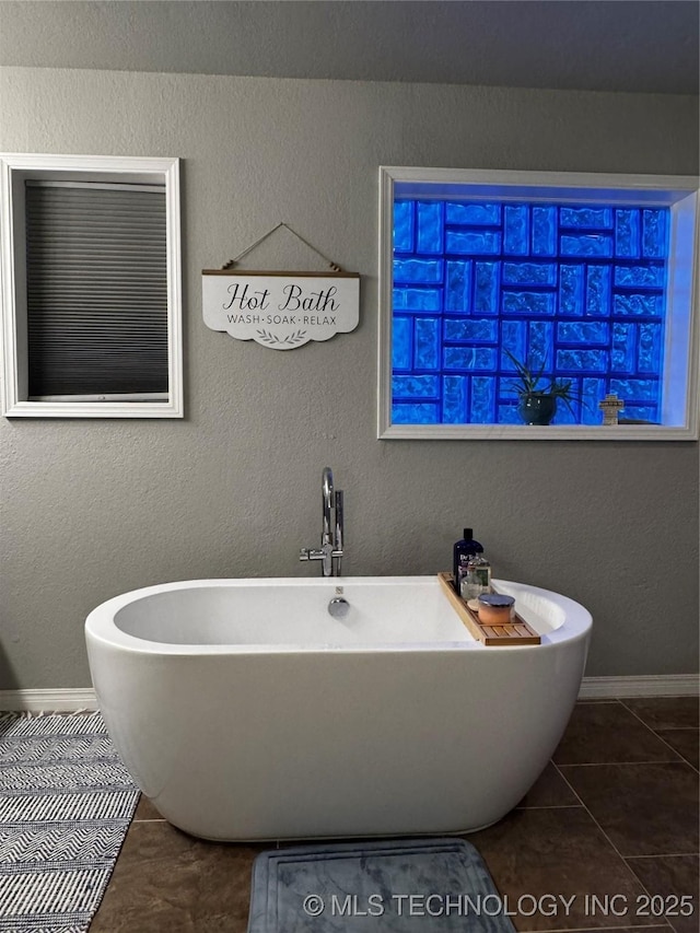 1105 Ono Ct, Mcalester, OK 74501 - bathroom with tile patterned floors, a freestanding bath, and baseboards