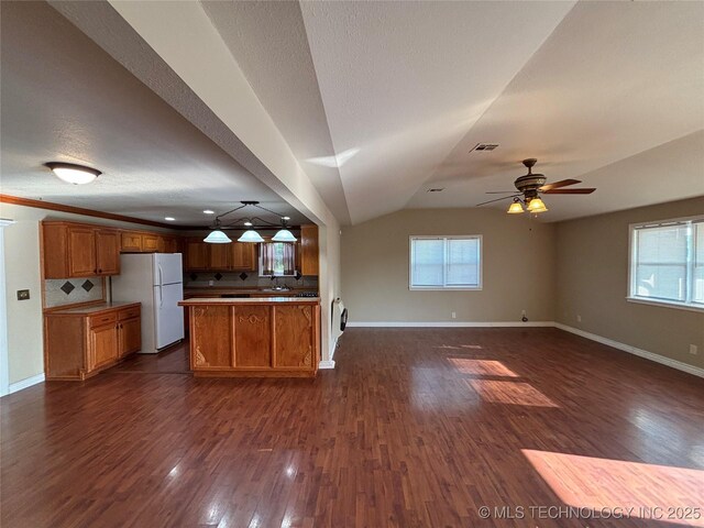 9412 S 55th St, Muskogee, OK 74403 - kitchen featuring freestanding refrigerator, open floor plan, ceiling fan, brown cabinetry, and lofted ceiling