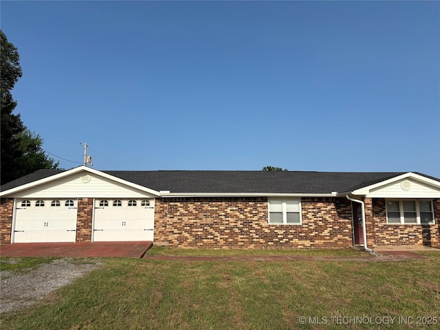 9412 S 55th St, Muskogee, OK 74403 - single story home featuring brick siding, an attached garage, driveway, and a front yard