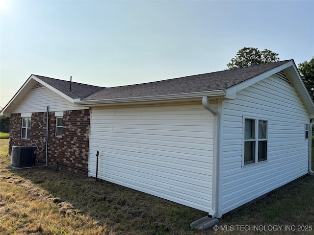 9412 S 55th St, Muskogee, OK 74403 - view of side of property with central air condition unit, roof with shingles, and brick siding