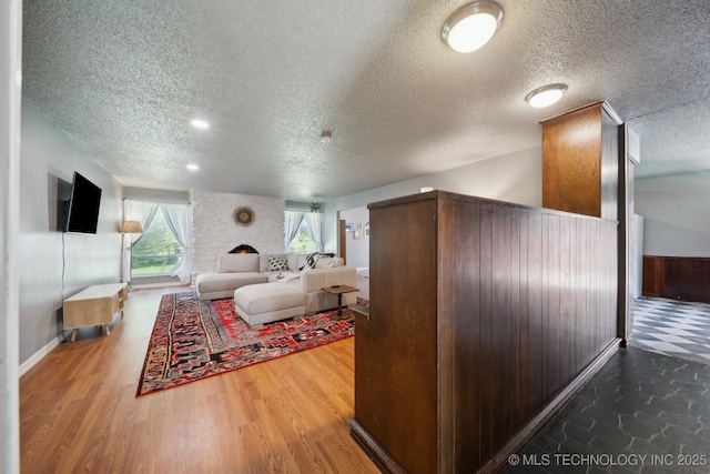 6960 S Oswego Ave, Tulsa, OK 74136 - living area with a textured ceiling and wood finished floors