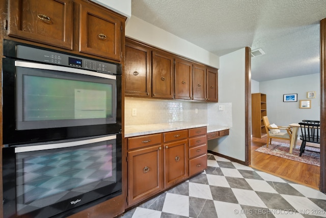6960 S Oswego Ave, Tulsa, OK 74136 - kitchen featuring double wall oven, light countertops, dark flooring, beverage cooler, and a textured ceiling