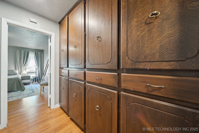 6960 S Oswego Ave, Tulsa, OK 74136 - detailed view of a textured ceiling, wood finished floors, and baseboards
