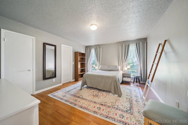 6960 S Oswego Ave, Tulsa, OK 74136 - bedroom featuring a textured ceiling, wood finished floors, and baseboards