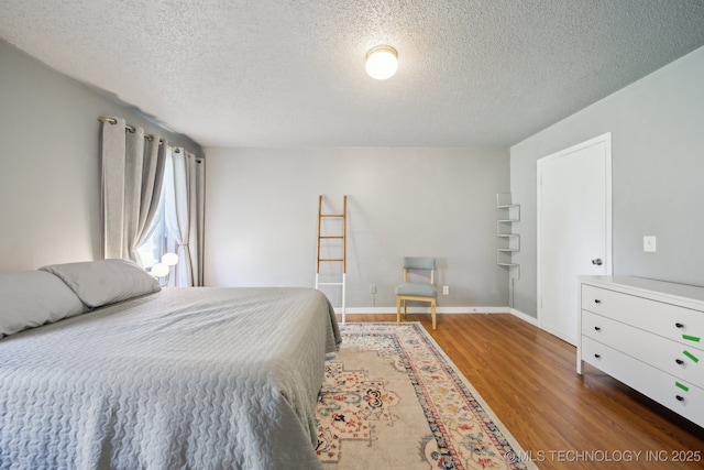 6960 S Oswego Ave, Tulsa, OK 74136 - bedroom featuring wood finished floors and a textured ceiling