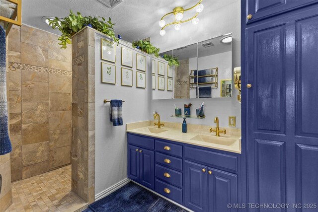 722 E 18th St, Ada, OK 74820 - bathroom featuring double vanity, a walk in shower, and baseboards