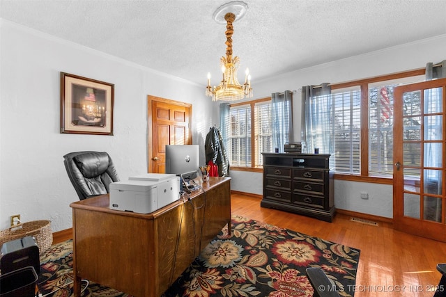 722 E 18th St, Ada, OK 74820 - office space with a chandelier, a textured ceiling, wood finished floors, baseboards, and ornamental molding