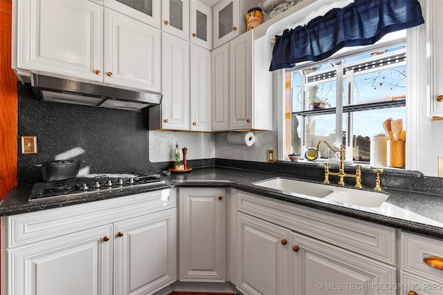 722 E 18th St, Ada, OK 74820 - kitchen with a sink, white cabinets, stainless steel gas cooktop, under cabinet range hood, and decorative backsplash