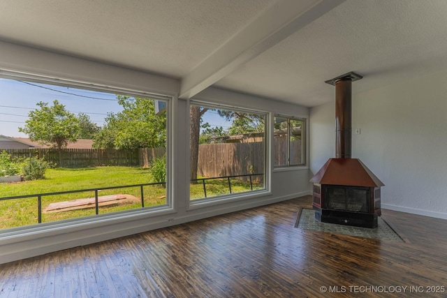 5726 E 26th St, Tulsa, OK 74114 - unfurnished sunroom featuring a wood stove, healthy amount of natural light, and beam ceiling