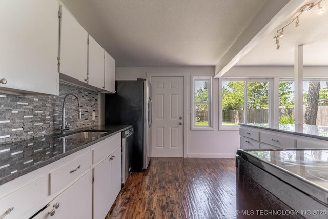 5726 E 26th St, Tulsa, OK 74114 - kitchen featuring a sink, stainless steel appliances, decorative backsplash, white cabinetry, and dark stone countertops