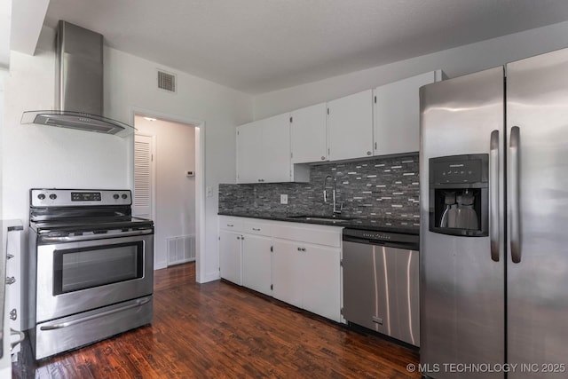 5726 E 26th St, Tulsa, OK 74114 - kitchen featuring stainless steel appliances, wall chimney range hood, a sink, dark countertops, and backsplash
