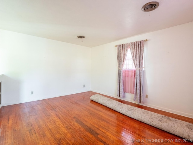 1412 S 9th, Mcalester, OK 74501 - unfurnished room with wood finished floors and baseboards