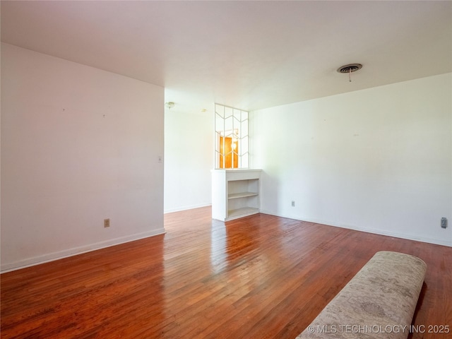 1412 S 9th, Mcalester, OK 74501 - unfurnished living room with wood finished floors and baseboards