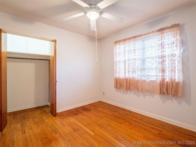 1412 S 9th, Mcalester, OK 74501 - unfurnished bedroom featuring light wood-style flooring, baseboards, a closet, and a ceiling fan