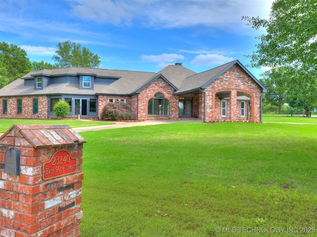 23240 E 90th St S, Broken Arrow, OK 74014 - view of front of home with brick siding, a front lawn, and a shingled roof