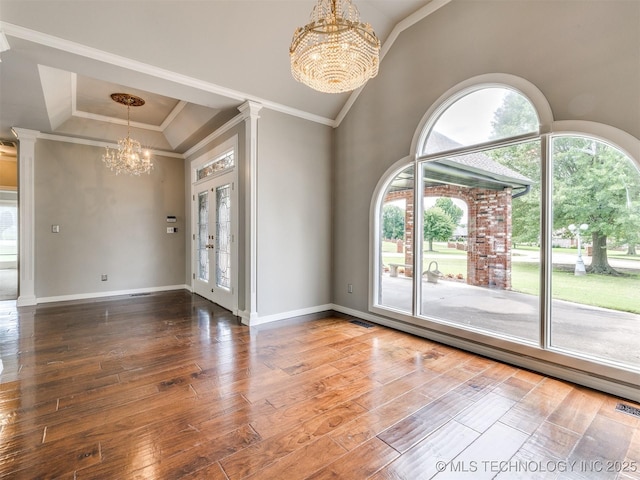 23240 E 90th St S, Broken Arrow, OK 74014 - empty room featuring a chandelier, wood-type flooring, ornate columns, baseboards, and ornamental molding