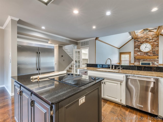 23240 E 90th St S, Broken Arrow, OK 74014 - kitchen with appliances with stainless steel finishes, a sink, a ceiling fan, dark stone countertops, and white cabinets