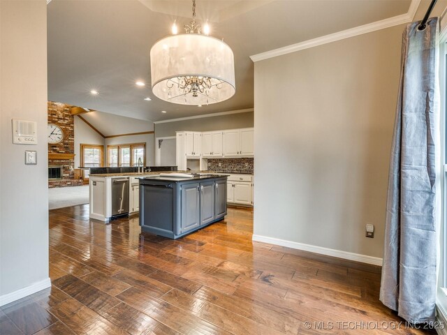 23240 E 90th St S, Broken Arrow, OK 74014 - kitchen with white cabinets, dark wood-style floors, vaulted ceiling, a kitchen island, and open floor plan