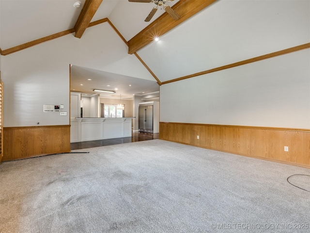 23240 E 90th St S, Broken Arrow, OK 74014 - unfurnished living room featuring beam ceiling, carpet floors, wainscoting, ceiling fan, and high vaulted ceiling