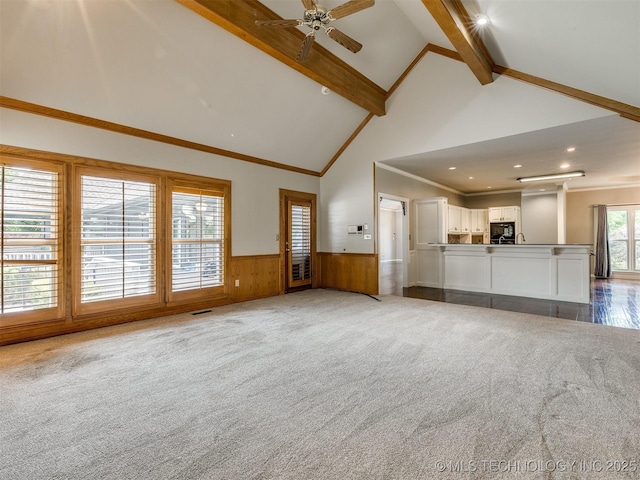 23240 E 90th St S, Broken Arrow, OK 74014 - unfurnished living room featuring high vaulted ceiling, beam ceiling, wainscoting, carpet floors, and ceiling fan