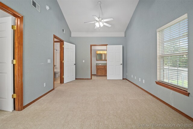 15 W Ridge Way, Bristow, OK 74010 - unfurnished bedroom with connected bathroom, carpet floors, baseboards, high vaulted ceiling, and a ceiling fan