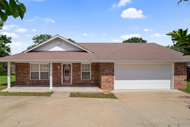 15 W Ridge Way, Bristow, OK 74010 - ranch-style home featuring brick siding, concrete driveway, a garage, a porch, and roof with shingles