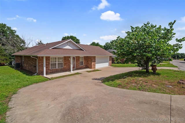 15 W Ridge Way, Bristow, OK 74010 - ranch-style home with concrete driveway, brick siding, an attached garage, a front lawn, and central AC unit