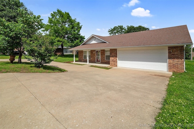 15 W Ridge Way, Bristow, OK 74010 - view of front of house featuring driveway, an attached garage, brick siding, and a front lawn