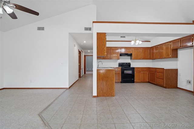 15 W Ridge Way, Bristow, OK 74010 - kitchen with electric range, under cabinet range hood, brown cabinets, ceiling fan, and light countertops
