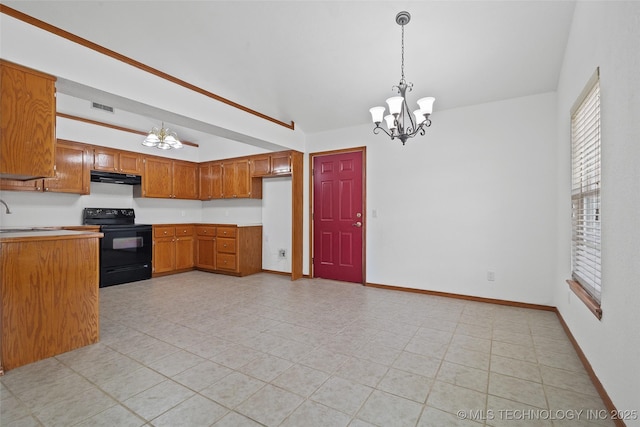15 W Ridge Way, Bristow, OK 74010 - kitchen with black electric range oven, under cabinet range hood, a chandelier, brown cabinetry, and vaulted ceiling