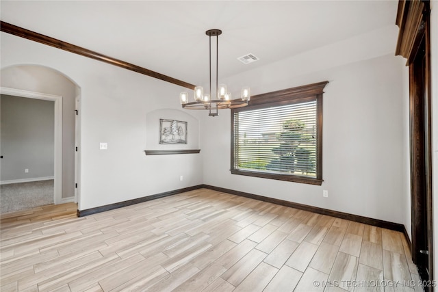9015 N 65th E Pl, Owasso, OK 74055 - empty room with light wood-style flooring, baseboards, and arched walkways