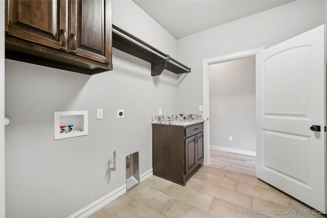 9015 N 65th E Pl, Owasso, OK 74055 - laundry area with hookup for a washing machine, cabinet space, hookup for an electric dryer, gas dryer hookup, and baseboards