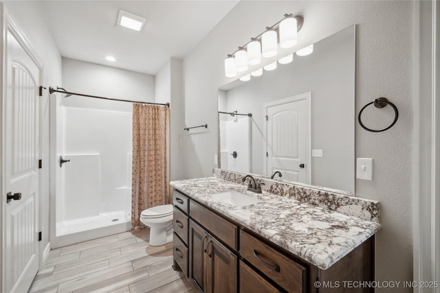 9015 N 65th E Pl, Owasso, OK 74055 - bathroom featuring vanity, toilet, a shower with shower curtain, and wood finish floors