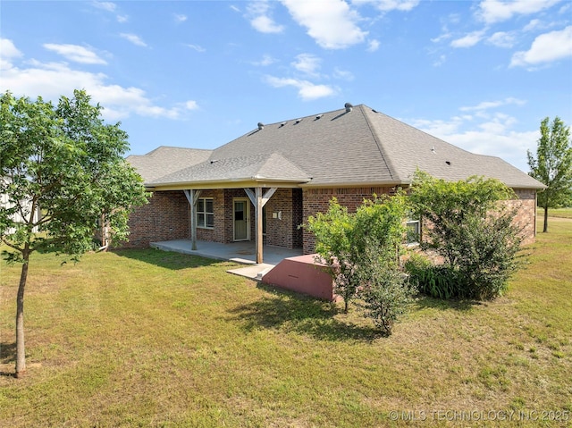 4180 Countyline, Ardmore, OK 73401 - back of property with a patio, brick siding, a yard, and a shingled roof