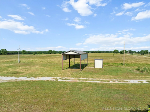 4180 Countyline, Ardmore, OK 73401 - view of community with a yard, a detached carport, and a rural view