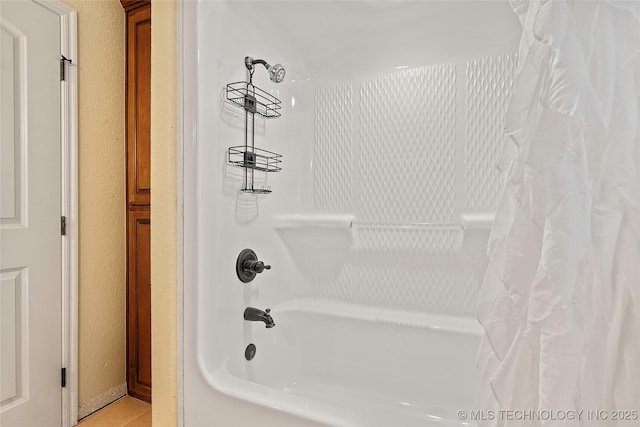 4180 Countyline, Ardmore, OK 73401 - full bathroom with shower / bath combo with shower curtain, tile patterned floors, and a textured wall