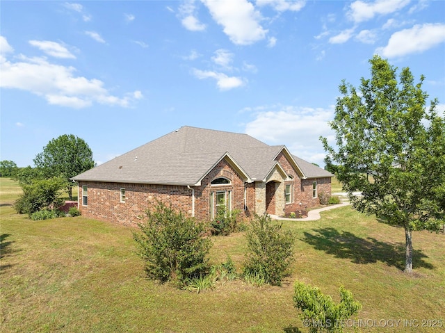 4180 Countyline, Ardmore, OK 73401 - view of front of home with brick siding, a front yard, and a shingled roof