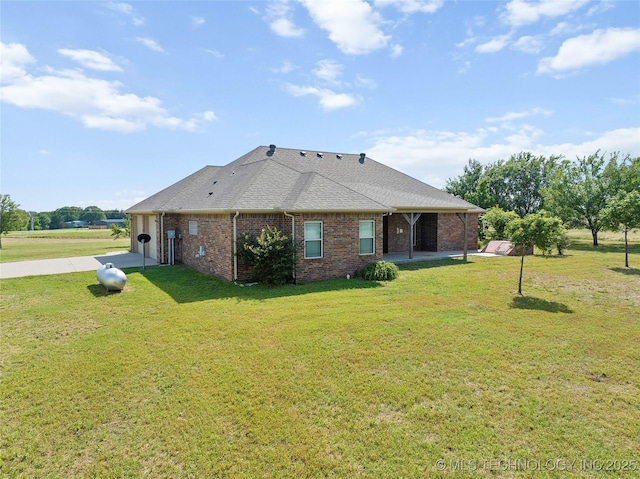 4180 Countyline, Ardmore, OK 73401 - rear view of property featuring brick siding, a lawn, concrete driveway, and a shingled roof