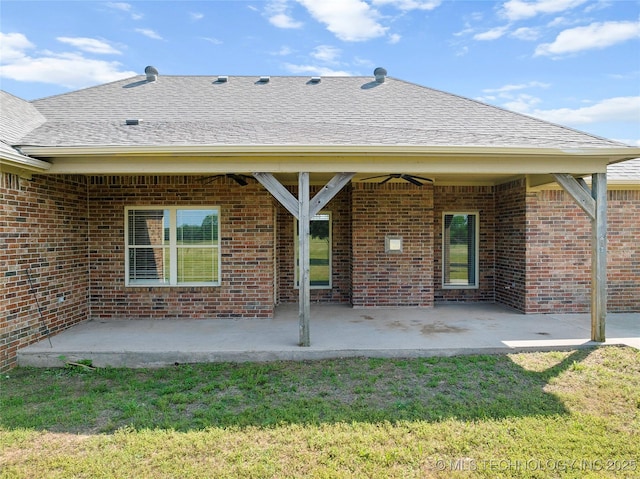 4180 Countyline, Ardmore, OK 73401 - back of house with brick siding, a patio, a lawn, ceiling fan, and a shingled roof