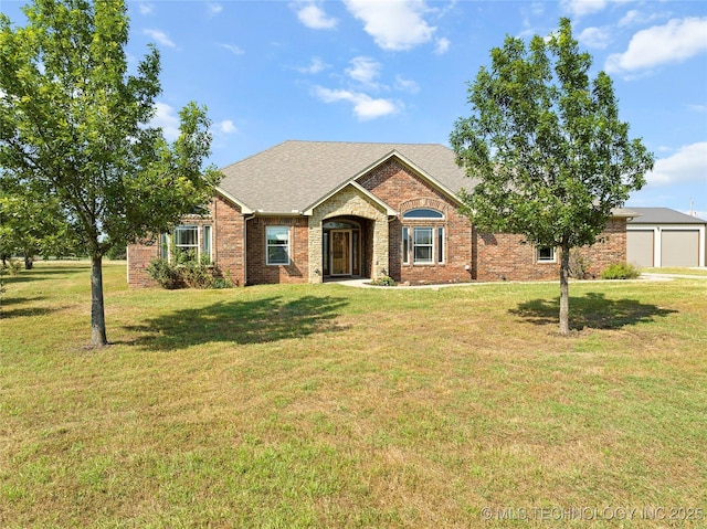 4180 Countyline, Ardmore, OK 73401 - view of front of house with brick siding, a front yard, a garage, and roof with shingles