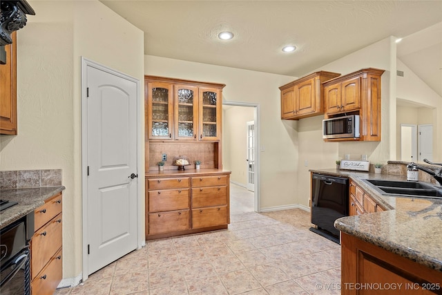 4180 Countyline, Ardmore, OK 73401 - kitchen with black appliances, a sink, brown cabinets, glass insert cabinets, and dark stone counters