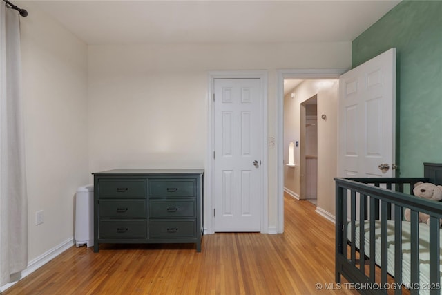 1228 S Erie Ave, Tulsa, OK 74112 - bedroom with light wood-type flooring and baseboards