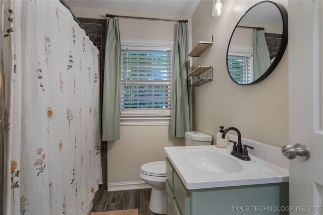 1228 S Erie Ave, Tulsa, OK 74112 - bathroom featuring toilet, vanity, baseboards, wood finished floors, and a shower with shower curtain