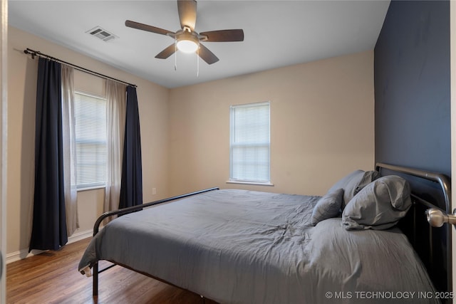 1228 S Erie Ave, Tulsa, OK 74112 - bedroom with wood finished floors, baseboards, and ceiling fan