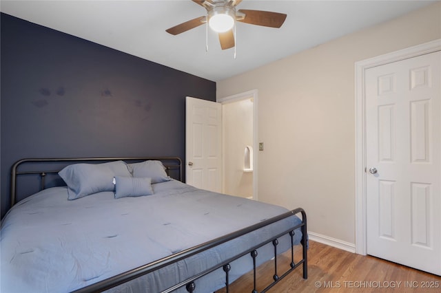 1228 S Erie Ave, Tulsa, OK 74112 - bedroom with wood finished floors, baseboards, and ceiling fan