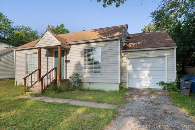 1228 S Erie Ave, Tulsa, OK 74112 - view of front facade featuring asphalt driveway, a garage, a front lawn, entry steps, and a shingled roof