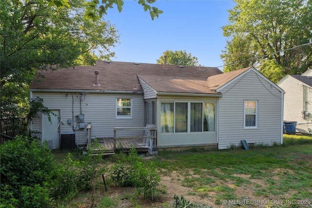 1228 S Erie Ave, Tulsa, OK 74112 - rear view of property featuring a wooden deck, roof with shingles, a lawn, and central air condition unit