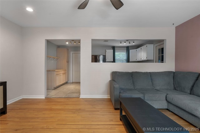 1228 S Erie Ave, Tulsa, OK 74112 - living area featuring track lighting, light wood-style flooring, baseboards, and ceiling fan