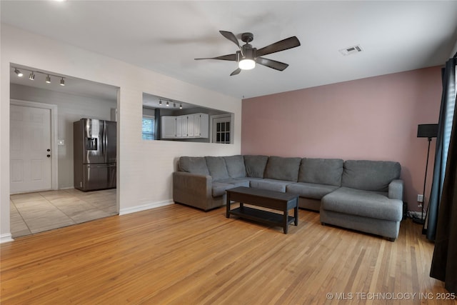1228 S Erie Ave, Tulsa, OK 74112 - living area with light wood-type flooring, ceiling fan, and baseboards